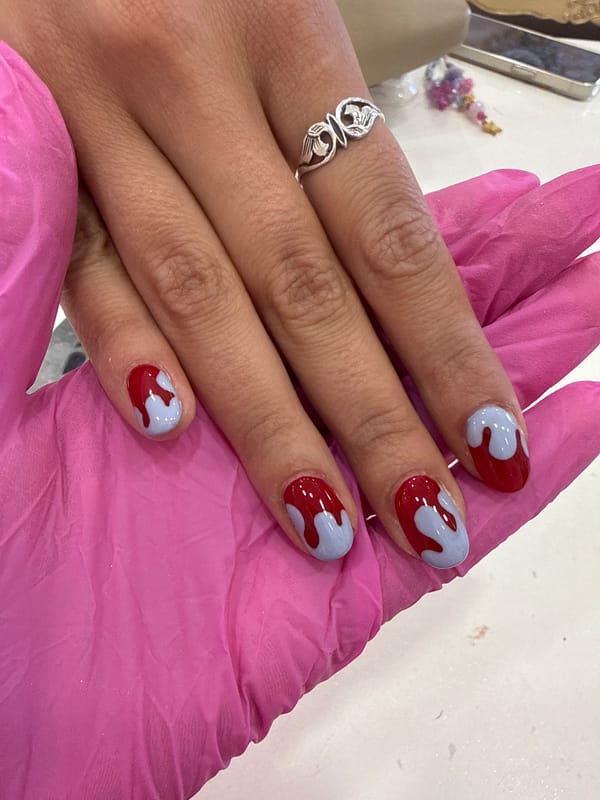 Fresh manicure with red-purple nail art completed in Sofia salon
