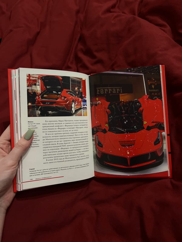Person reads Ferrari racing book in Дачное, Russia