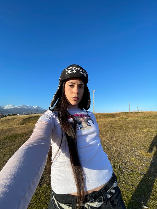 Woman takes outdoor selfie under clear skies in Ushuaia