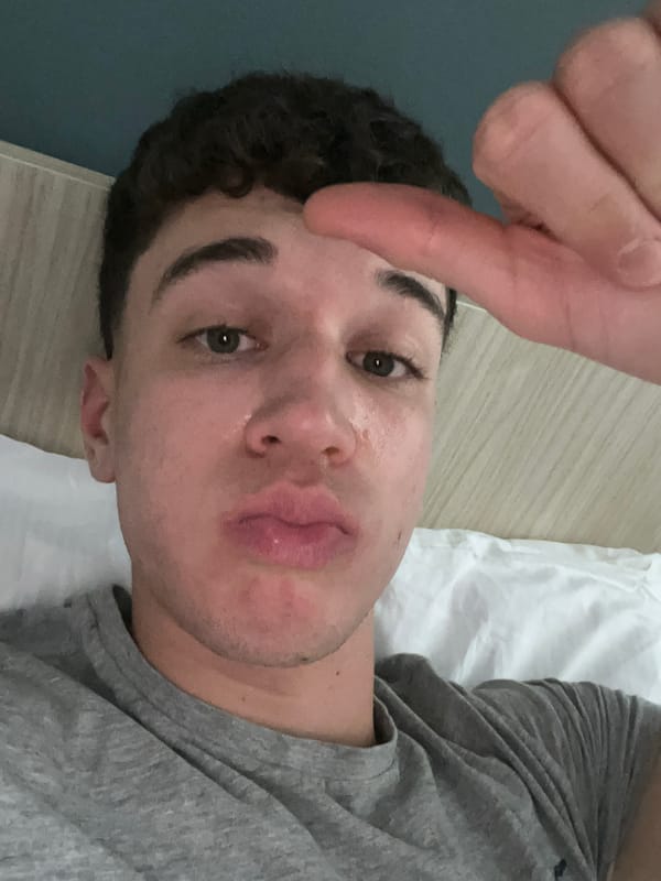 Person takes selfie while lying in bed in Turin