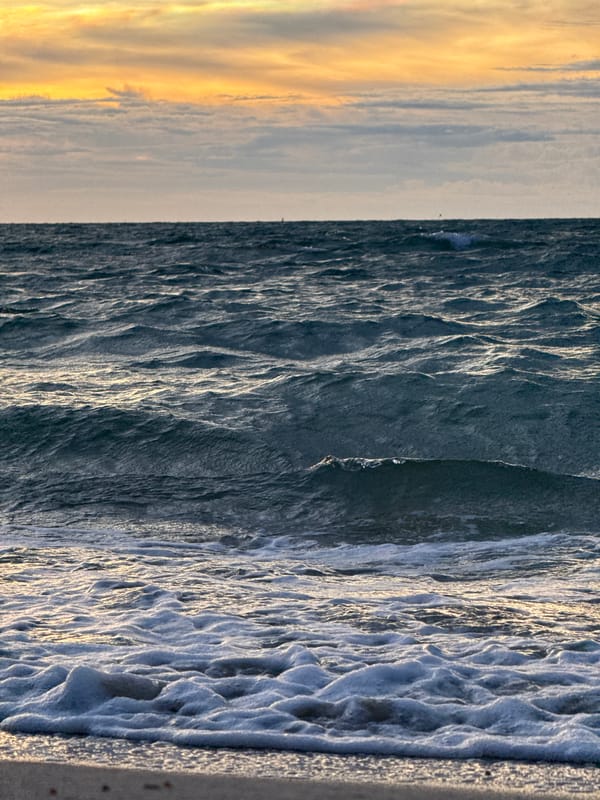 Child plays in surf at Baan Tai beach, Thailand