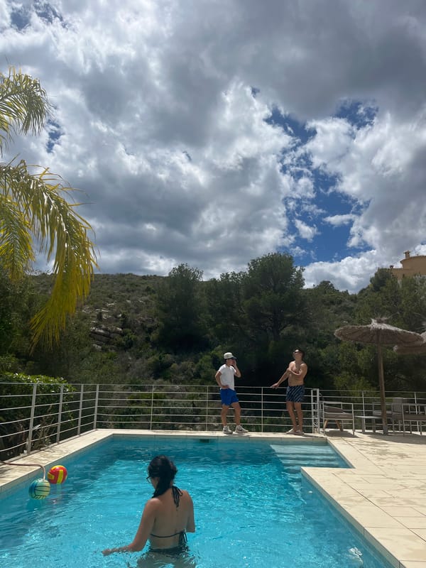 Pool gathering with water games in Spanish coastal town