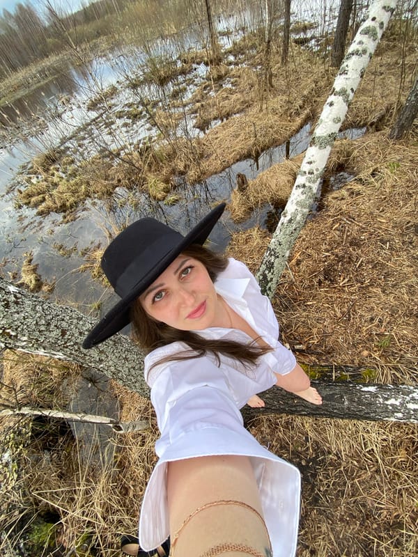 Woman in black hat photographed outdoors in Марковский, Russia