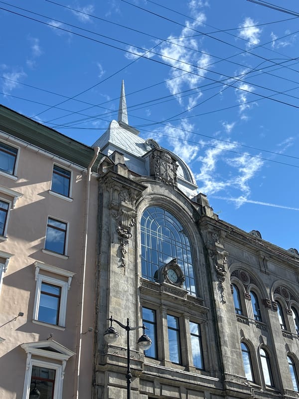 Historic street scene with facade work, bikes, and a snack break