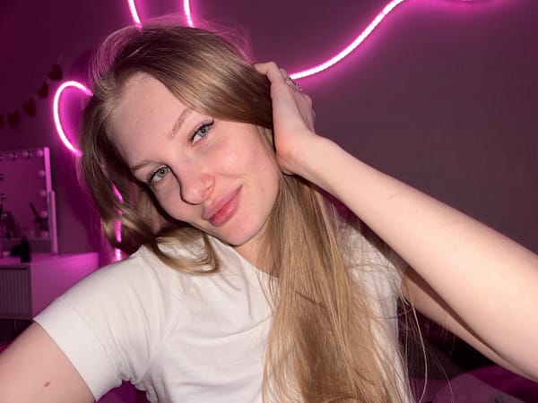 Young woman photographs herself in bedroom in Perm, Russia