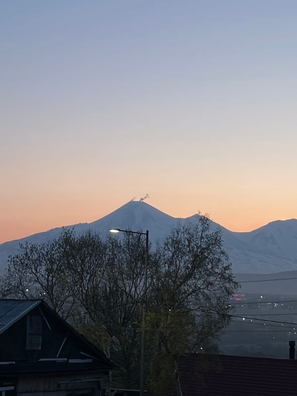Dawn breaks over fog-covered Petropavlovsk-Kamchatsky amid volcanic peaks