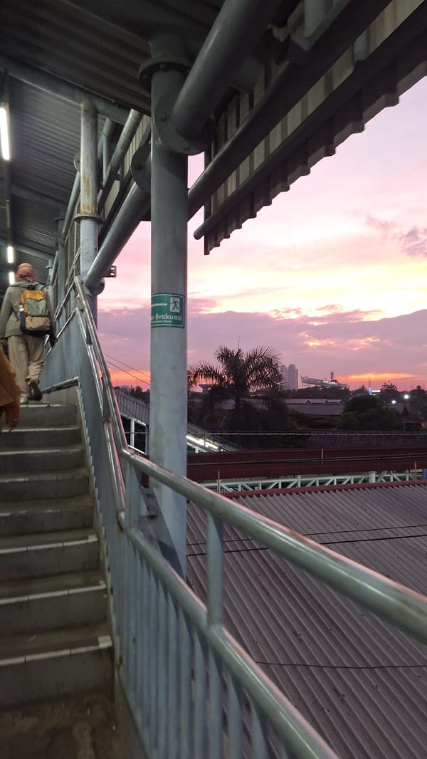 Man photographed on staircase during sunset in North Jakarta