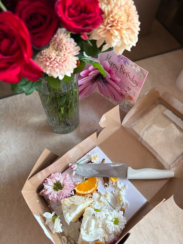 Woman documents breakfast with flowers in Mengwi kitchen
