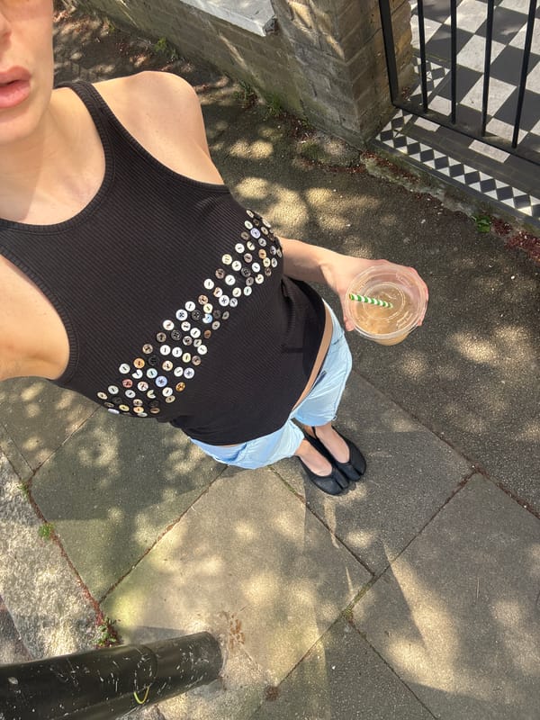 Person with drink observed standing by railing in London