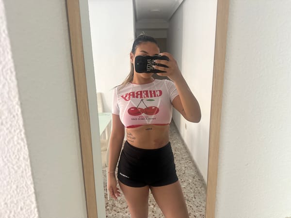 Woman takes mirror selfies in cherry-print top in Alicante
