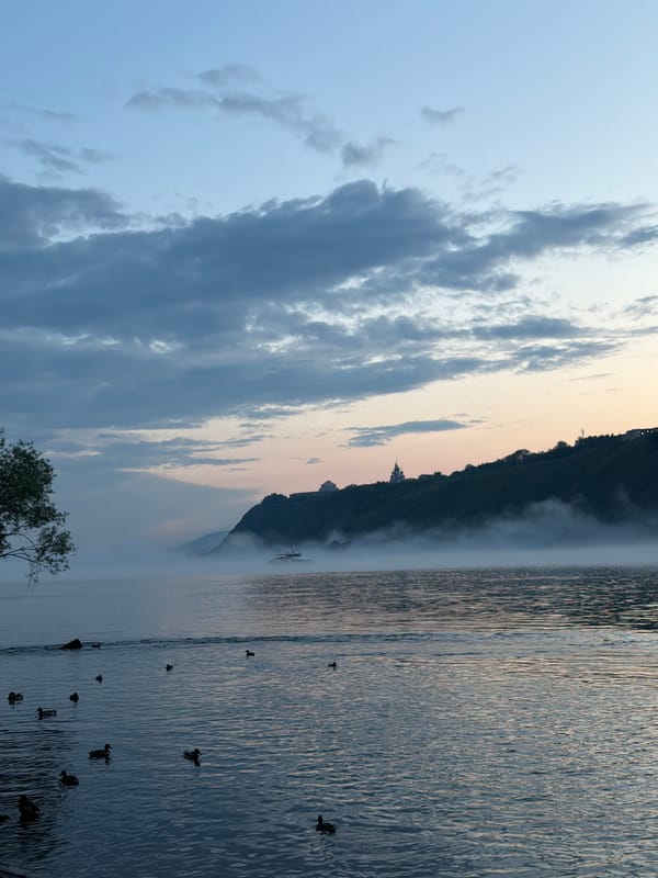 Passenger ship glides through morning mist on the Yenisei River