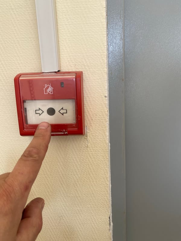 Person observed near emergency equipment in unidentified building
