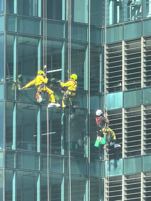 Workers clean windows on Cape Town high-rise building