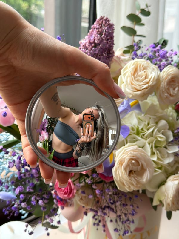 Person Takes Creative Mirror Selfie with Flowers in Budva