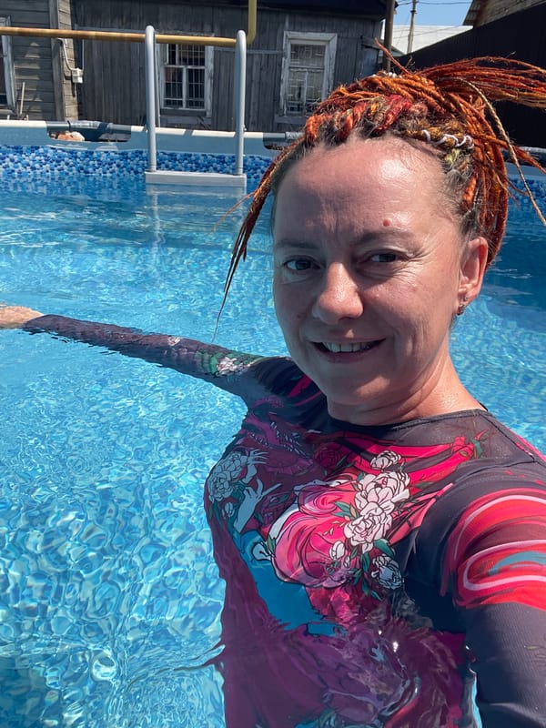 Tabby cat on a brick patio, pool selfies nearby