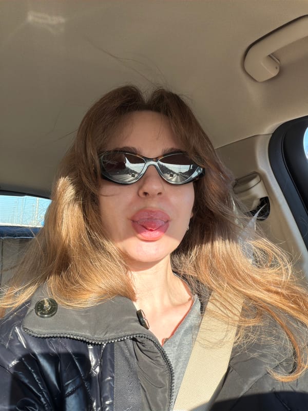 Woman takes playful selfie inside vehicle in Moscow