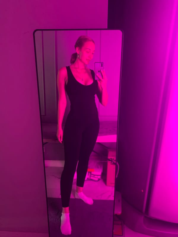 Mirror selfie in neon-lit room, Almaty