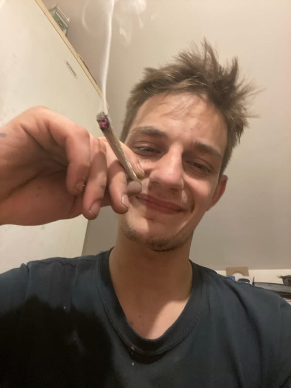 Rolling and smoking marijuana, close-up and casual