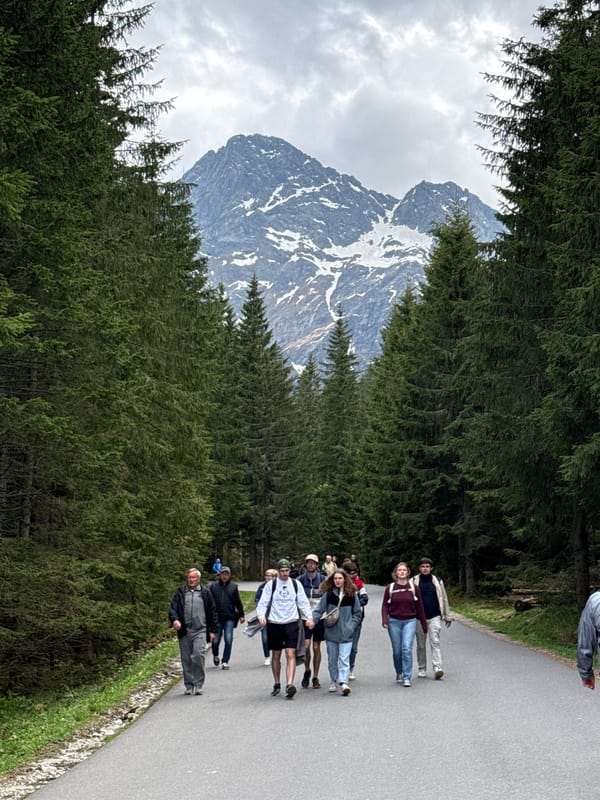 Group takes mountain walking tour in Brzegi, Poland