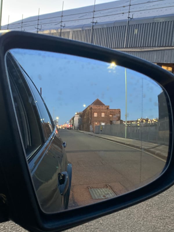 Car mirror captures street scene in East Suffolk