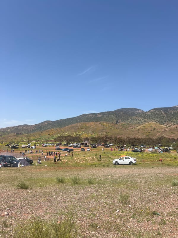 People gather with vehicles at Bin El Ouidane reservoir, Morocco