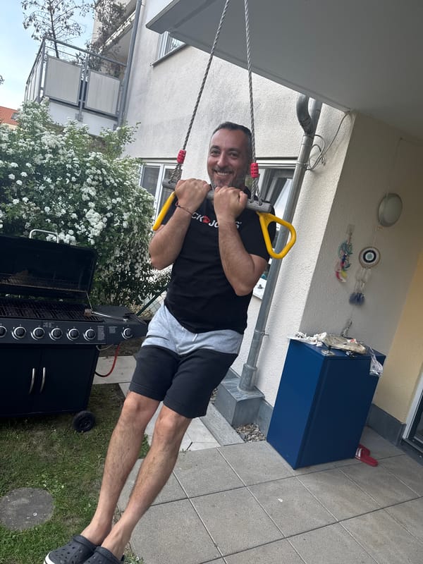 Man exercises with trapeze, soccer juggling in German backyard