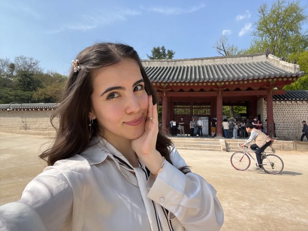 Woman takes selfies at traditional Korean building in Seoul