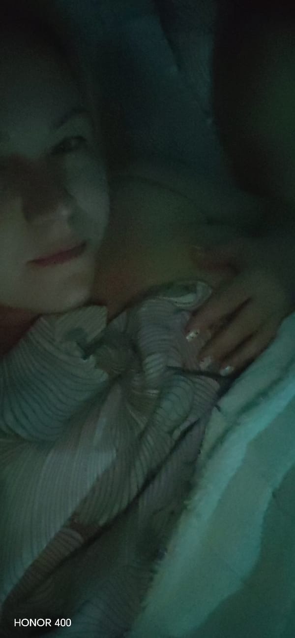 Person resting indoors in bedroom in Noviy, Russia