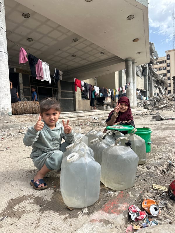 Gaza children play, collect water amid destruction and displacement