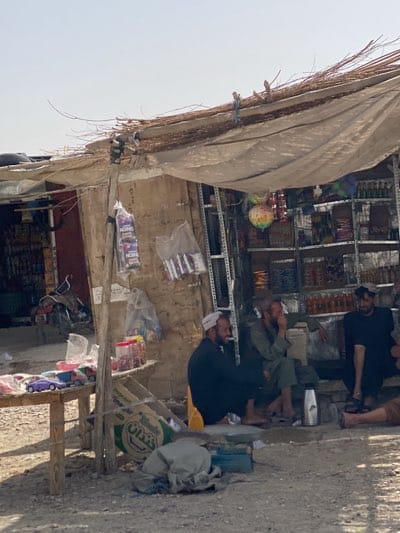 Men gather at roadside shop in Kandahar