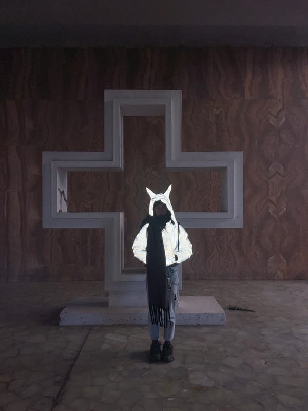 Person poses on concrete cross at Buenos Aires brutalist building