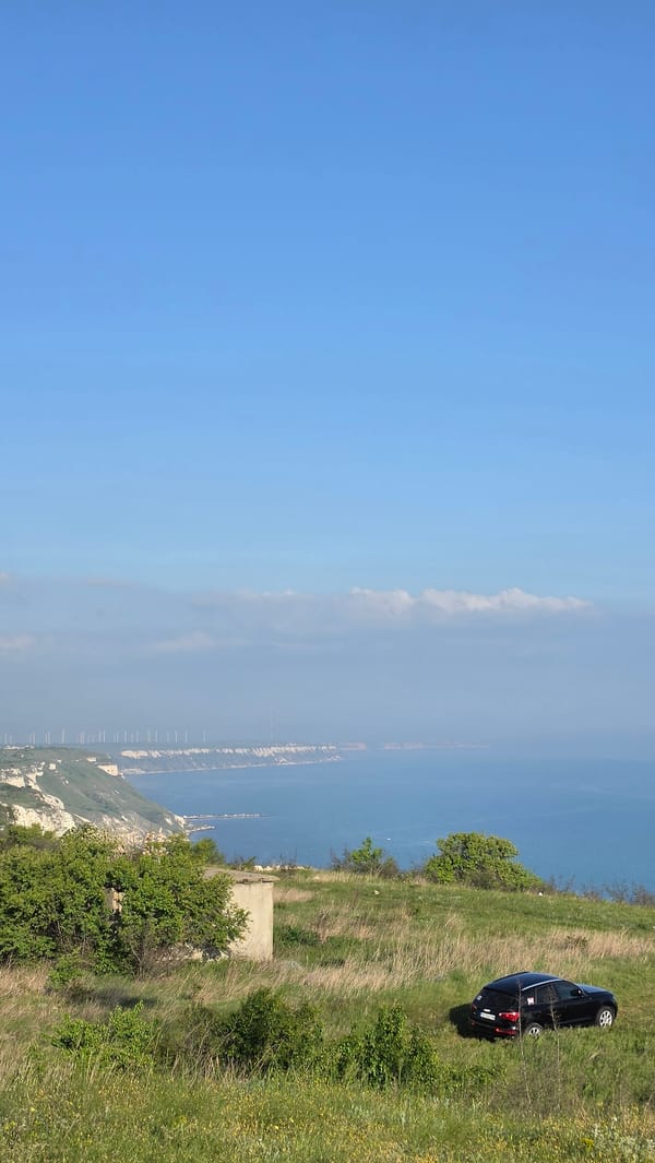 Black car parked on Bulgarian cliff overlooking Black Sea