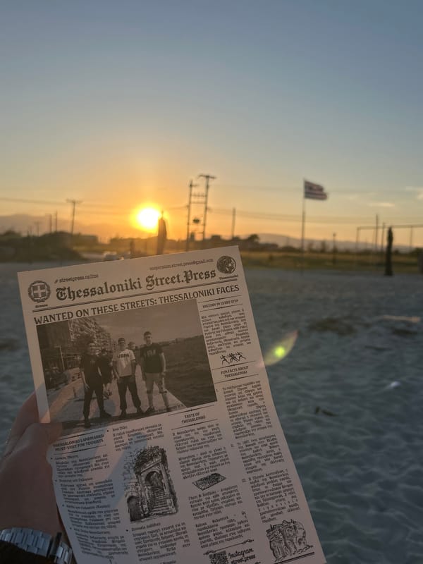 Young men photograph sunset at Greek beach gathering
