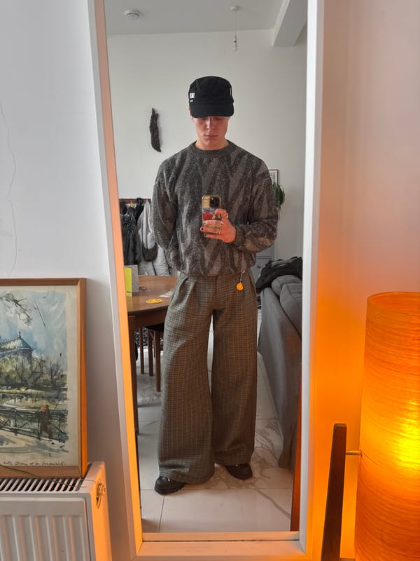 Person takes mirror selfie in London wearing Honda cap