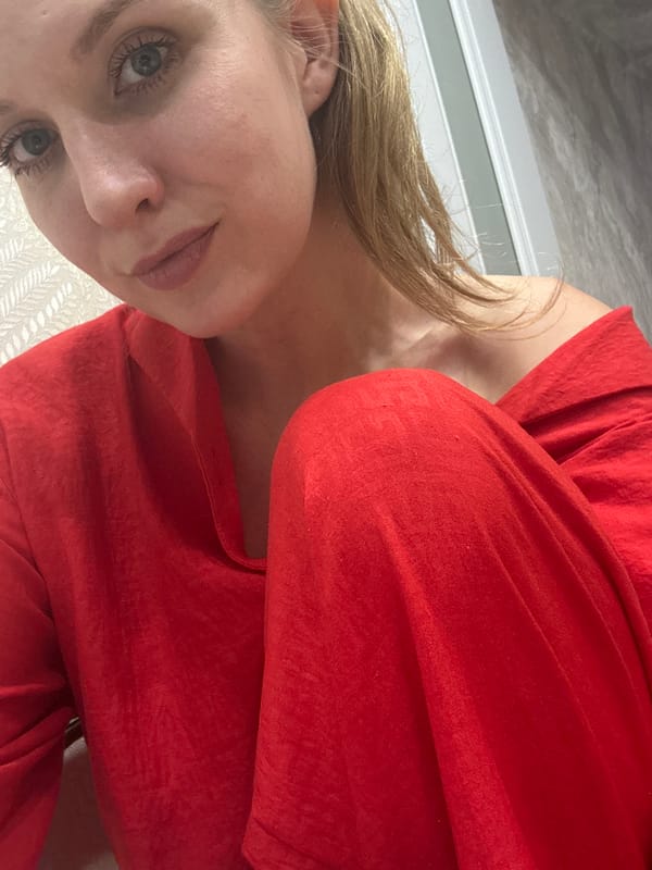 Woman in red pajamas conducts kitchen activities in Izhevsk home