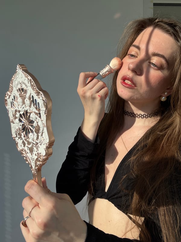 Getting ready: makeup application session with a vintage mirror