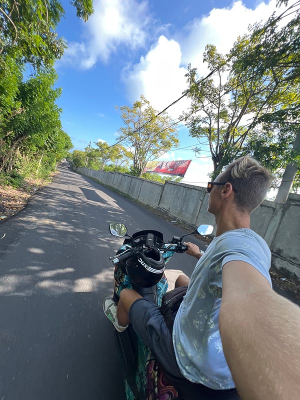 Man rides scooter through Ungasan, Indonesia streets