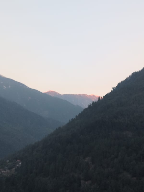 Dawn breaks over Himalayan peaks in Vashisht, India