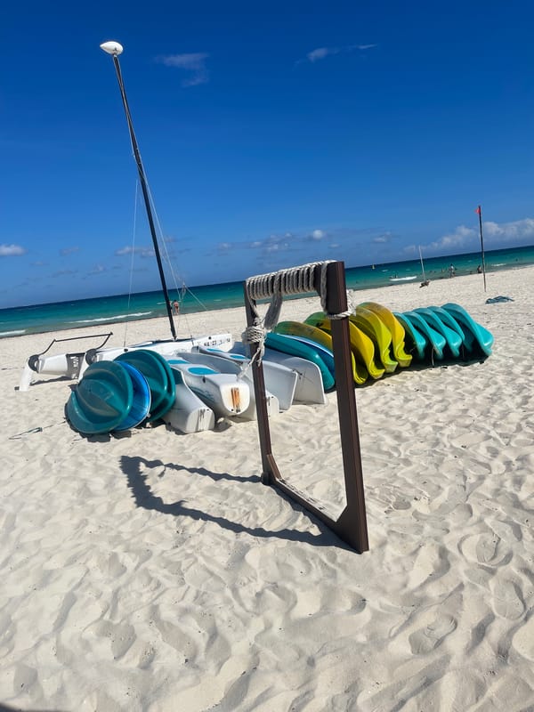 Kayaks stacked on sunny Playa del Carmen beach