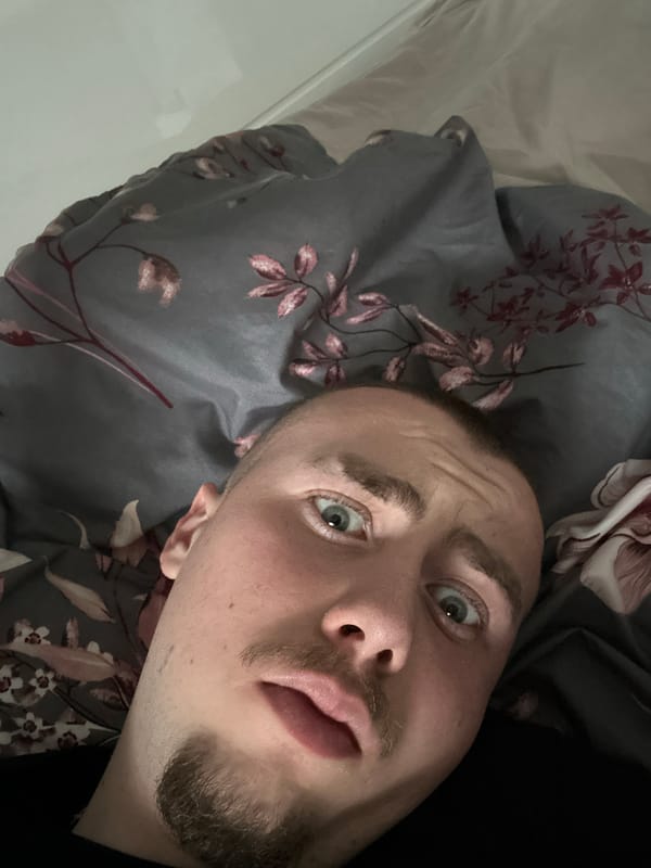 Man takes selfie on floral bedding in Sofia