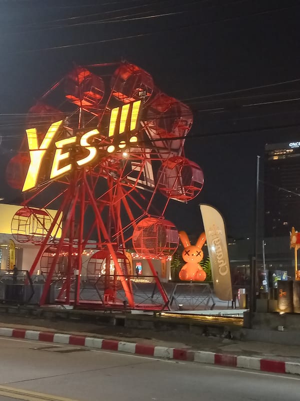 Pattaya nighttime attractions captured with illuminated Ferris wheel, decorative lighting