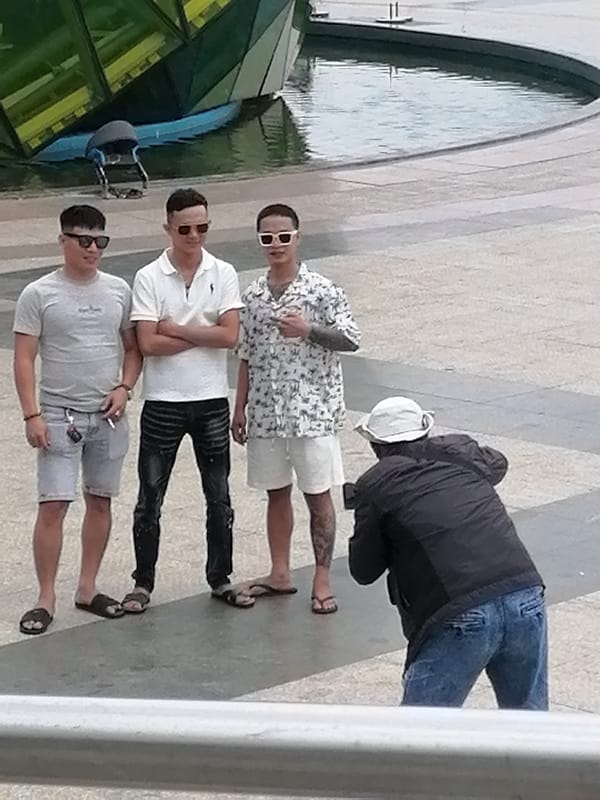 Group moment at a Da Lat public square near a water feature