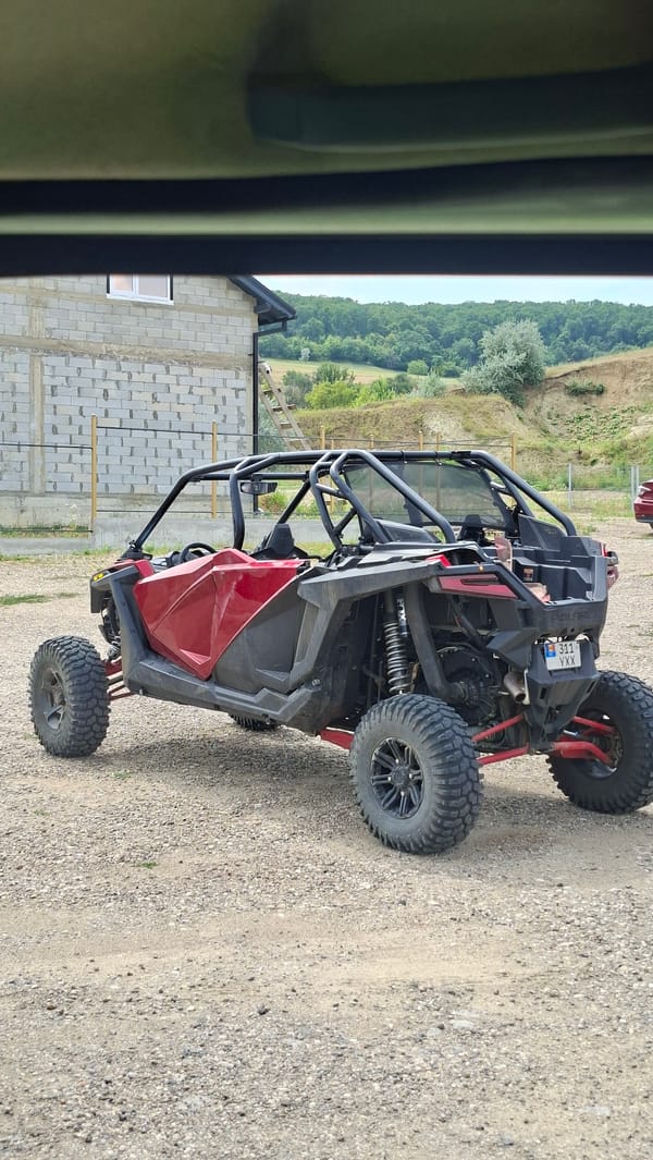 Polaris RZR parked on gravel near a construction site in Moldova