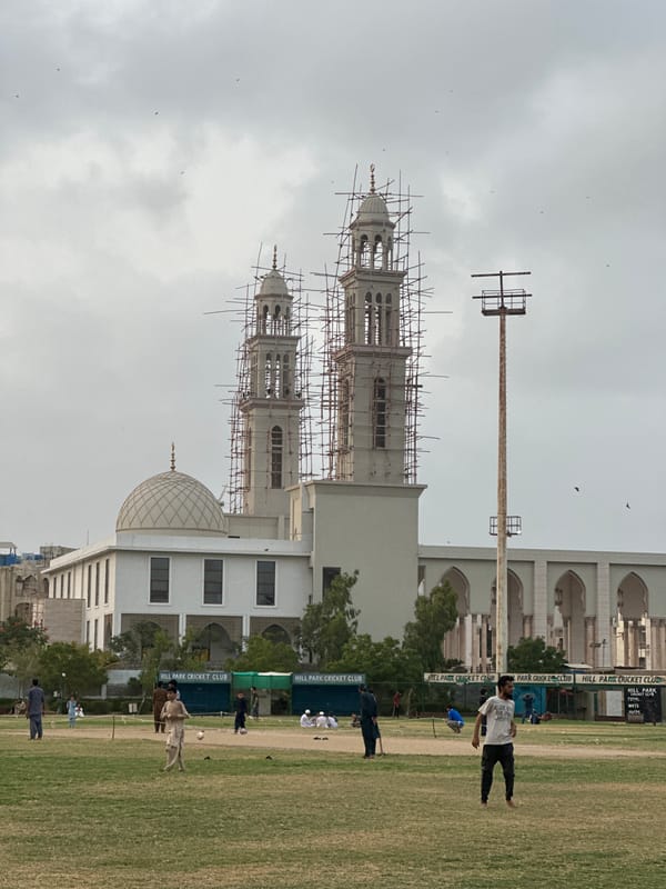 Cricket and construction: Karachi mosque rises behind a park field
