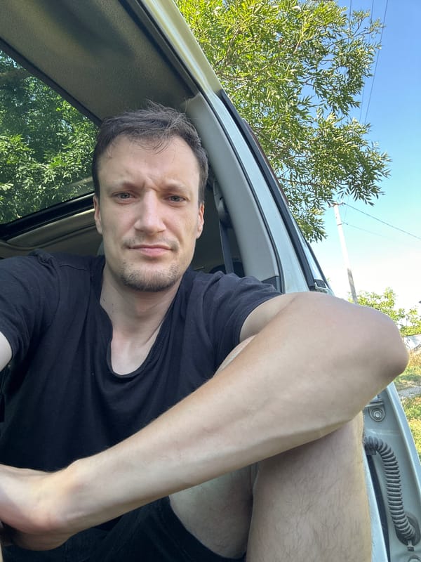 Parked Nissan, open door, selfies on a rural Ukrainian road