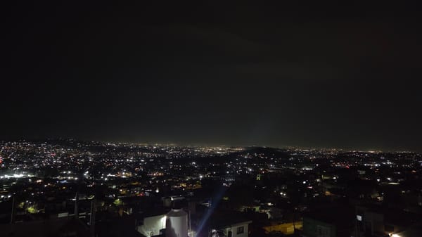 Nighttime cityscape captured in Tonalá, Mexico showing illuminated urban sprawl