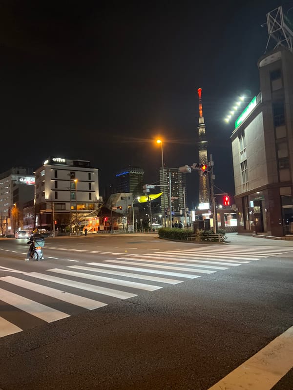 Tokyo Skytree illuminated red and white over Taito intersection