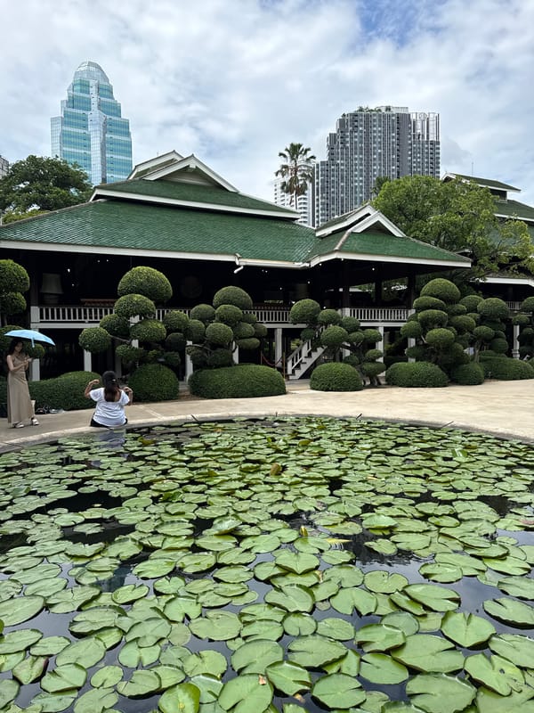 Morning tranquility captured at Bangkok's Lumphini Park amid urban skyline