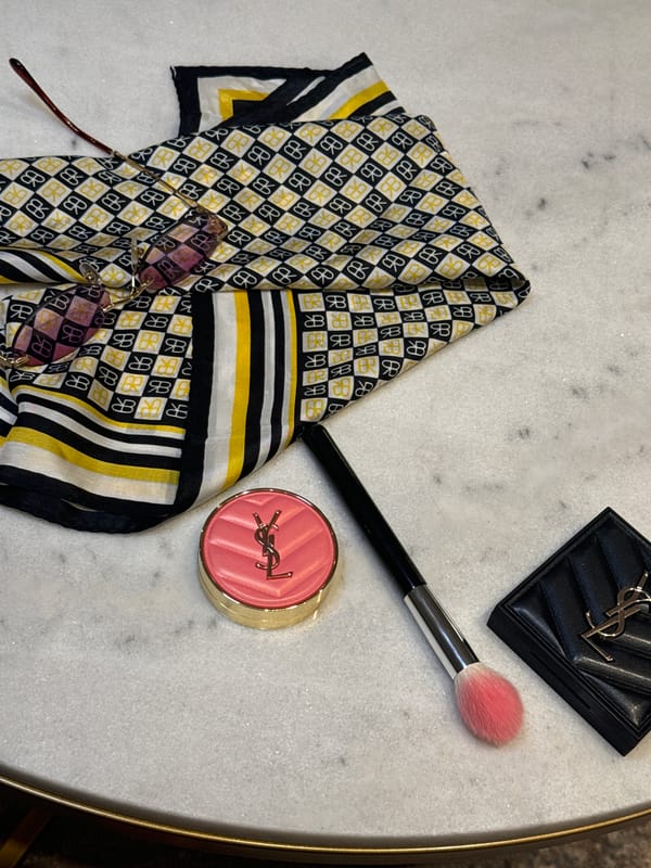 Woman applies makeup in armchair in Carnikava, Latvia