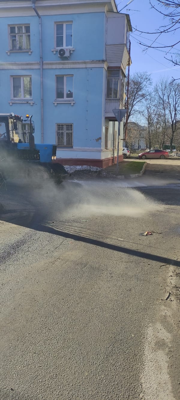 Morning street cleaning and resident activity in Fryazino, Russia